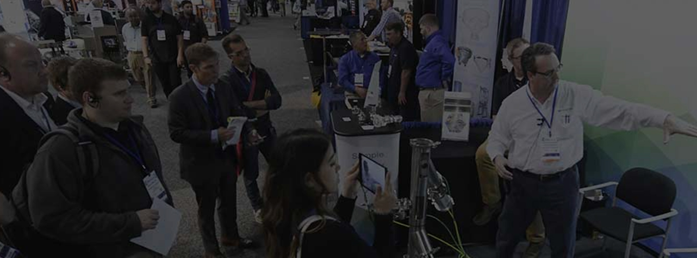 Exhibitor presenting products to group of people